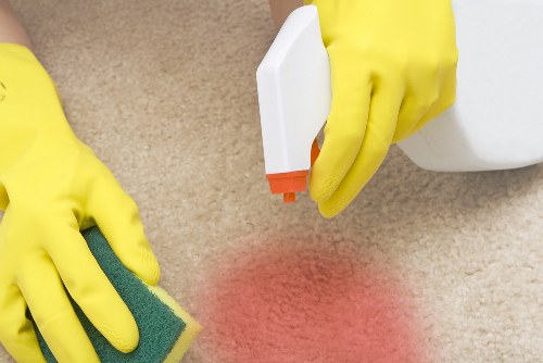 Carpet cleaning technician preparing equipment safely inside a home